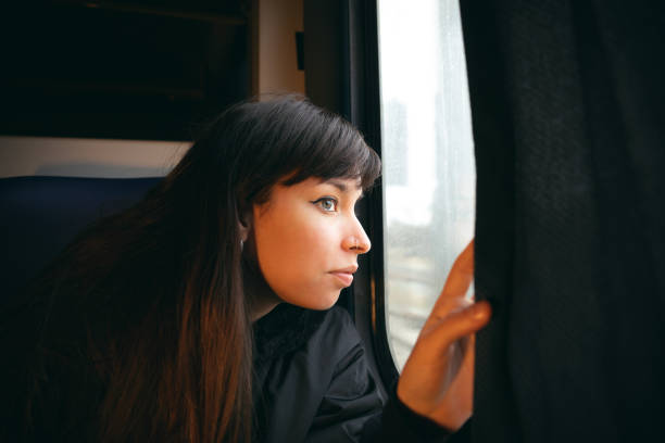 istock Young woman traveller look outside train window 1383889312