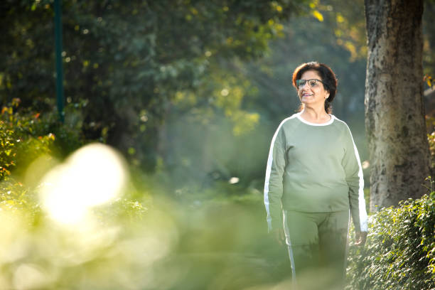 istock Old woman walking at park 1383890597