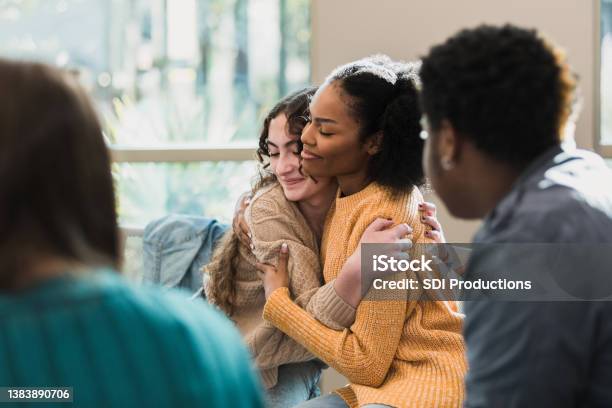 Friends Console Each Other Stock Photo - Download Image Now - Teenager, Mental Health, Group Therapy