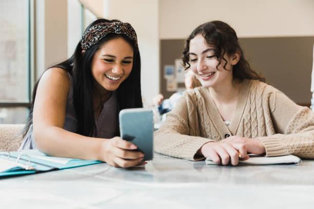 istock Girls read something funny on her phone 1383890725