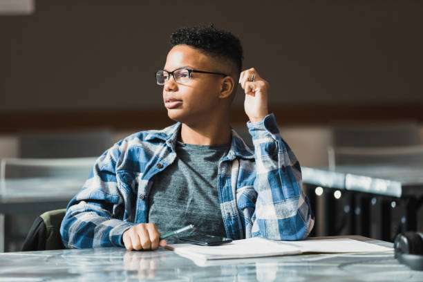 Young man listens to a group nearby