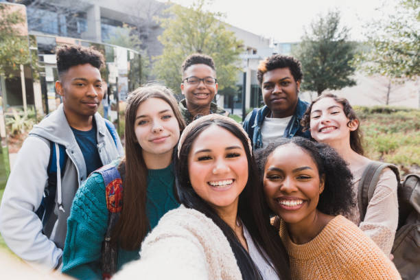 Group of friends The group of friends take a selfie outside school on a beautiful day. high school student stock pictures, royalty-free photos & images