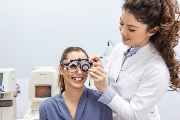 istock Eye health cheking with ophthalmological equipment in the laboratory. Using special device oculist trying to improve vision of young pretty girl. Working with medical devices for eye health. 1383898785