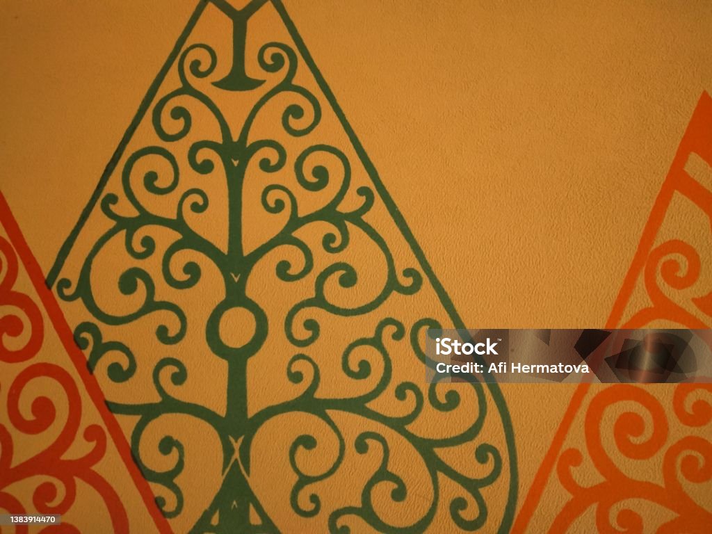 Picture of gunungan wayang on a wall as decoration The gunungan in Javanese called mountain is Conical or triangular structures/works (tapered top) inspired by the shape of a mountain (fire), a figure in the Indonesian theatrical performance of wayang Mountain Stock Photo