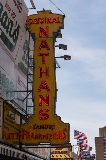 New York City, USA - June 4, 2019: The original Nathans Delicatessen on the boardwalk at Coney Island, in Brooklyn late in the day.