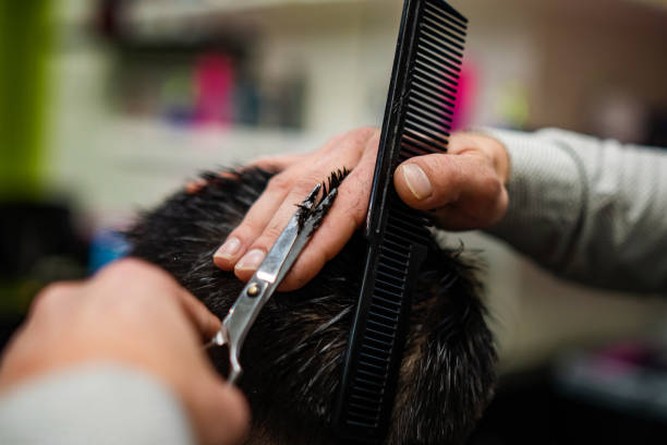 istock Unrecognizable male hands cutting hair 1383919045