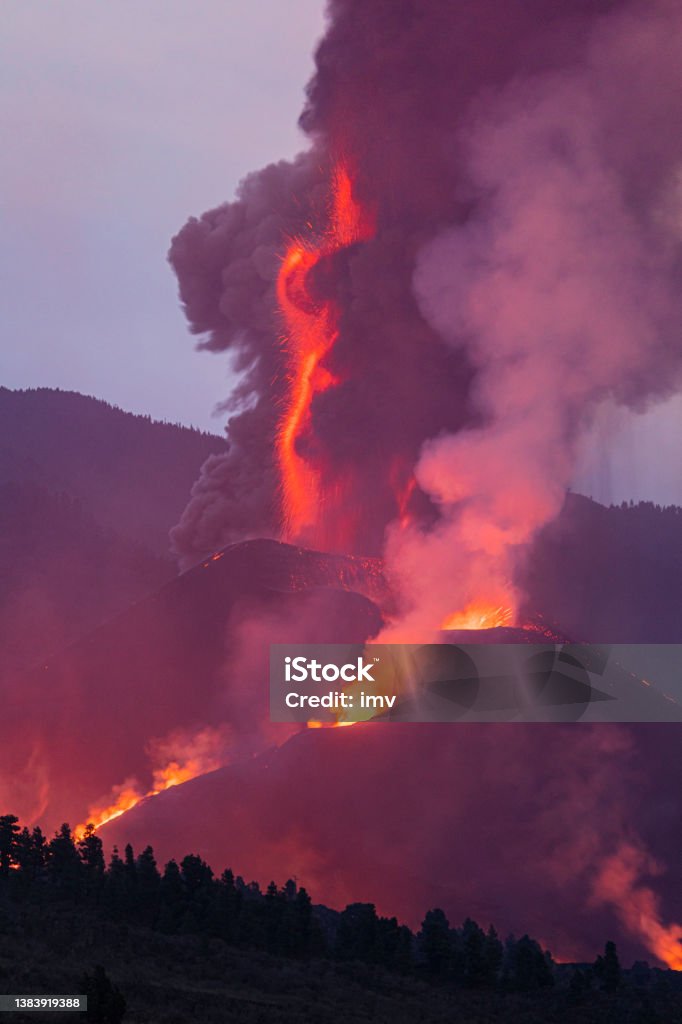 Cumbre Vieja's volcano eruption. Volcanic cone and volcanic bombs going dawnhill, huge ammount of gas and rocks. Palma volcanic Eruption. Crater and volcanic column Accidents and Disasters Stock Photo