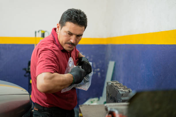 istock Latino male professional car mechanic prepares his tools to start work 1383920233