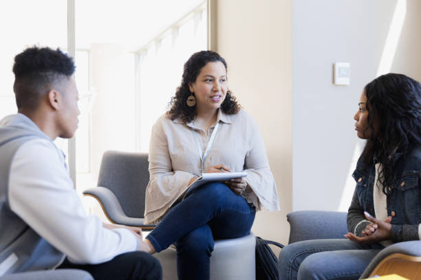 istock Female therapist mediates conflict between siblings 1383920785