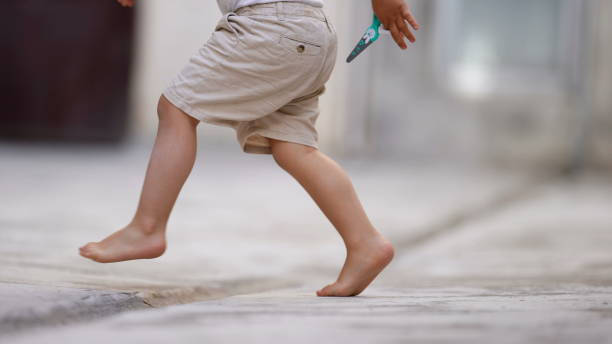 istock Child walking on tiptoes 1383930139