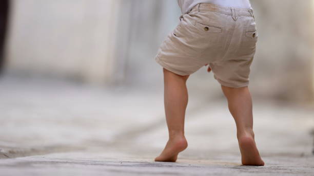 Child walking on tiptoes stock photo