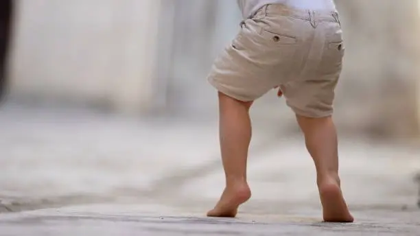 Photo of Child walking on tiptoes