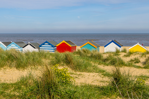 Beach huts with sand dunes at Southwold on the Suffolk coast
