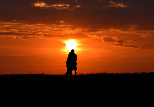 istock Sunset Heterosexual Lovers in silhouette on Baildon Moor 1383933181
