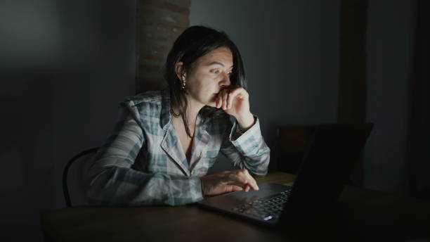 istock woman in front of laptop computer at night 1383933398