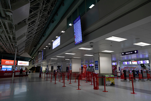 New Castle, UK - Dec. 12, 2021: Baggage check-in and departure area in one of the terminals at New Castle airport, at night, without people