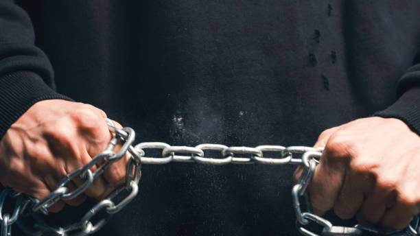 istock Close up of Hands Hold Iron Chain 1383933984