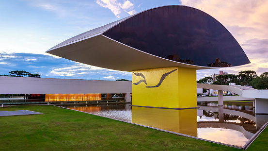 Curitiba, Parana, Brazil - March 31, 2014: view of the architecture of the Brazilian city of Curitiba in Parana state, Brazil showcasing the Eye Museum by Oscar Niemeyer with its eye shaped front buildings and the main building of the museum in the back on a sunny summer day.