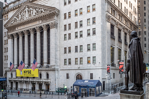 New York City - April 28 2015 : People outside of The New York Stock Market and Exchange building at the Manhattan Financial District