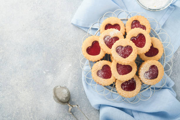istock Traditional Linzer cookie with strawberry jam and powder sugar on light grey beautiful background. Top view. Traditional homemade Austrian sweet dessert food on Valentines Day. Holiday snack concept. 1383943886