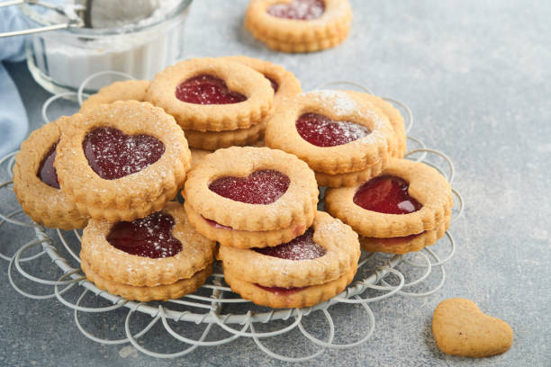 istock Traditional Linzer cookie with strawberry jam and powder sugar on light grey beautiful background. Top view. Traditional homemade Austrian sweet dessert food on Valentines Day. Holiday snack concept. 1383943972