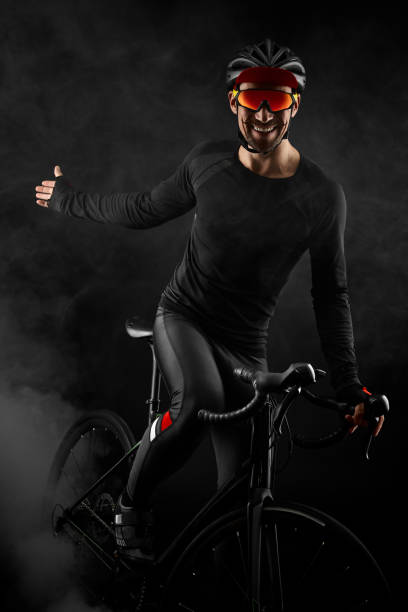 istock male cyclist with road bicycle on black background 1383947294
