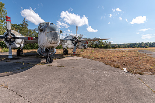 View of an abandoned propeller-driven aircraft plane on a public accessible runway