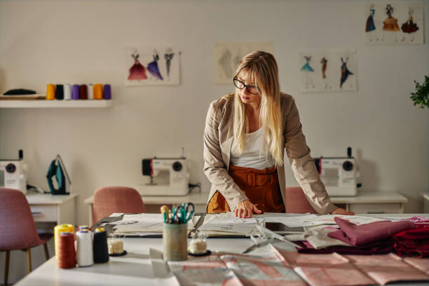 istock Young fashion designer working in her atelier 1383948320