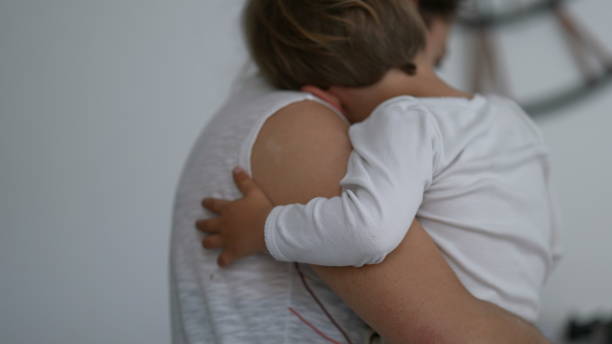 istock Mother multi-tasking at home holding child in arms 1383950001