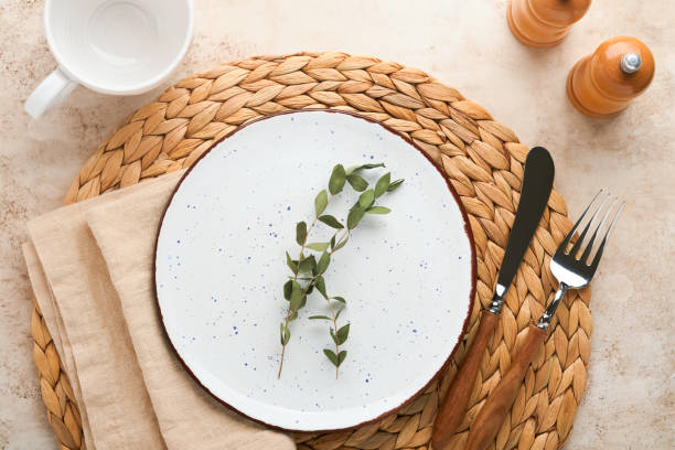 istock Vintage zero waste silverware. Rustic vintage set of white plate, wooden spoon and fork on napkin for dishes from water hyacinth on light gray concrete background. Empty dishes. Top view. Mock up. 1383950013