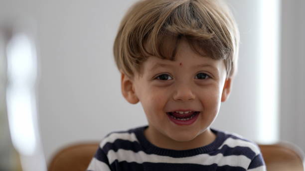 istock One adorable child portrait face smiling cute small boy 1383952243