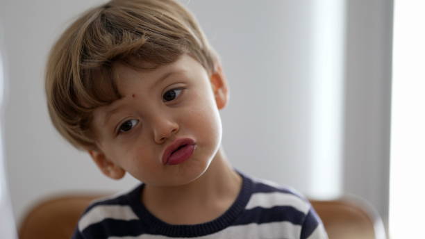 istock One adorable child portrait face smiling cute small boy 1383952377