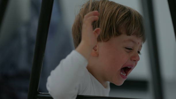 One crying little toddler child cries desperately doing a tantrum stock photo