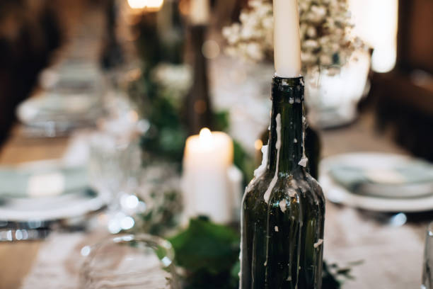 istock Table decoration for a festive dinner with candles in old bottles 1383953037