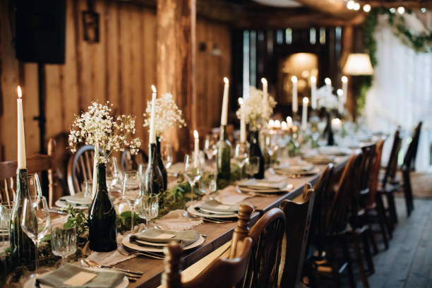 istock Decorating a wedding table for a holiday dinner with candles and flowers 1383953075