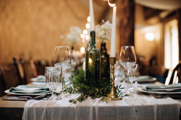 istock Table decoration for a festive dinner with candles in old bottles 1383953076
