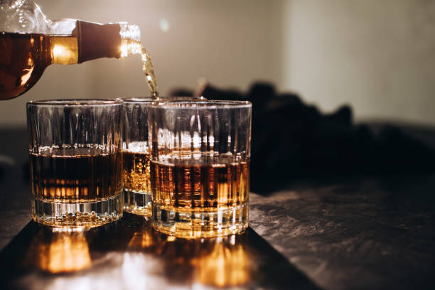 istock A man pours brandy into glasses at a restaurant at a party 1383953353