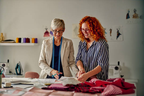 istock Fashion designers with sketches at workshop 1383955695