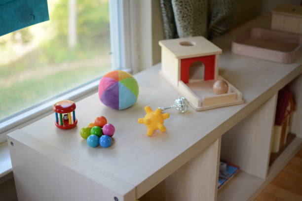 Montessori Toys for Babies A photo showing some infant toys in a prepared Montessori environment. montessori stock pictures, royalty-free photos & images