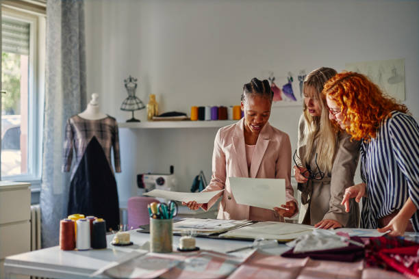 istock Creative people working together in fashion designer studio 1383959817