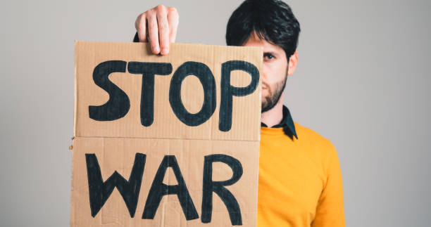 istock ukrainian guy holding a stop war placard in his hand 1383960947