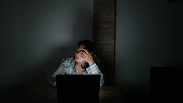 istock Tired woman in front of computer screen at night alone 1383961222