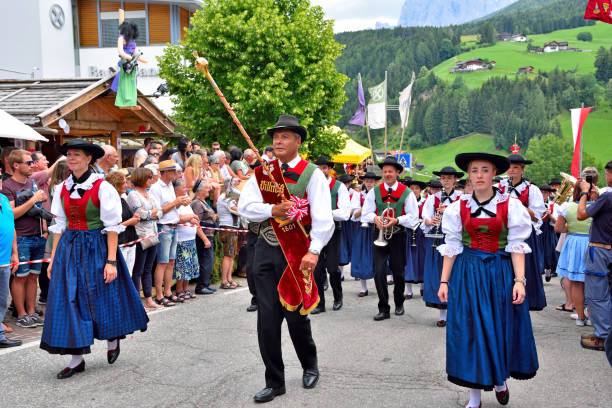 he musical orchestra in South Tyrolean costumes crosses the whole village playing typical songs villnosser dorffest, Feast of the village bread in the oven- July 8 2018 St Peter Val di Funes Italy