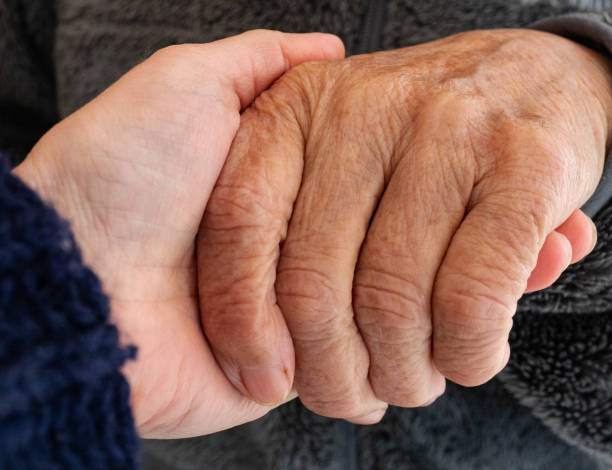 istock Mother and sun holding hands close up 1383963747