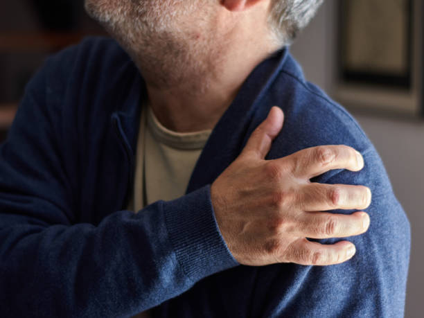 istock Close-up of an older man's hand resting on his shoulder. 1383964120