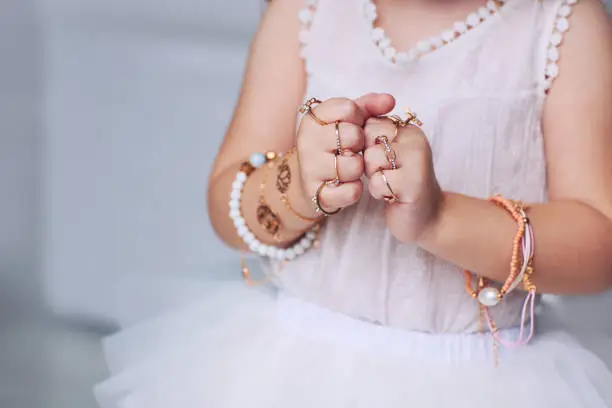 Photo of bijou jewelry rings on little baby girl hands