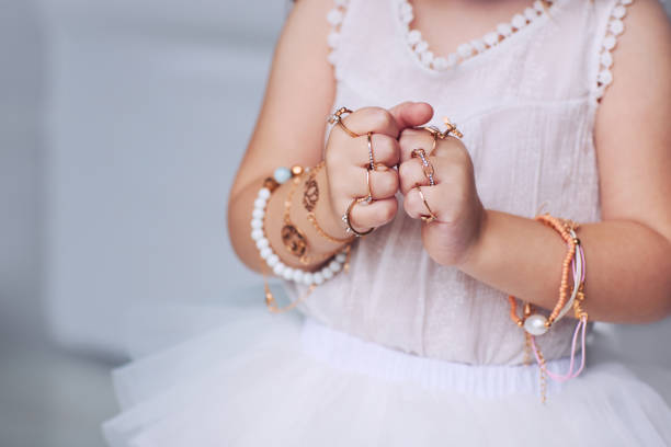 bijou jewelry rings on little baby girl hands - gem fashion jewelry bead imagens e fotografias de stock