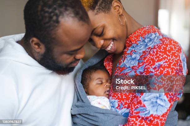 Young Parents With Their Baby Girl At Home Stock Photo - Download Image Now - Baby - Human Age, Newborn, Black People