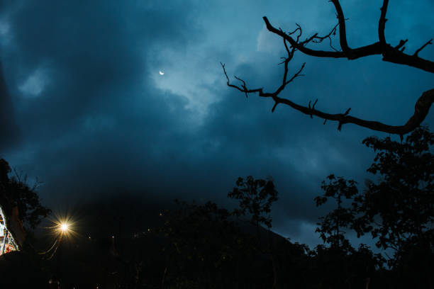 Heavy clouds on top of Girnar hills with moon in sky during night. Monsoon in mountains. Nature landscape. Heavy clouds on top of Girnar hills with moon in sky during night. Monsoon in mountains. Nature landscape. junagadh stock pictures, royalty-free photos & images