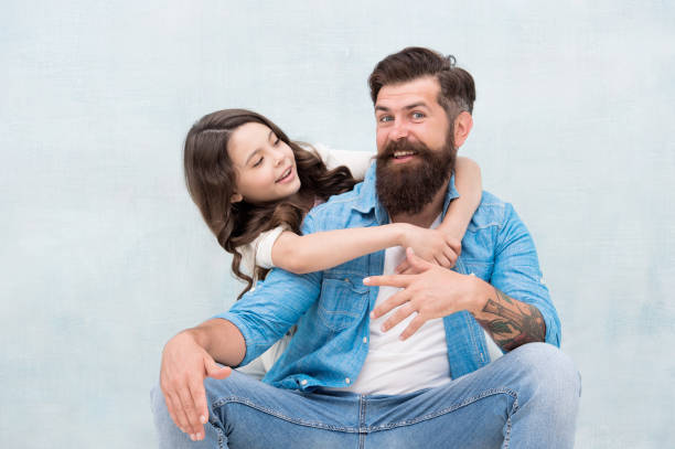 Honoring fathers and celebrating fatherhood. Little daughter hugging father on fathers day. Bearded man and small child celebrating international fathers day together. Happy fathers day Honoring fathers and celebrating fatherhood. Little daughter hugging father on fathers day. Bearded man and small child celebrating international fathers day together. Happy fathers day. fashionable dad stock pictures, royalty-free photos & images